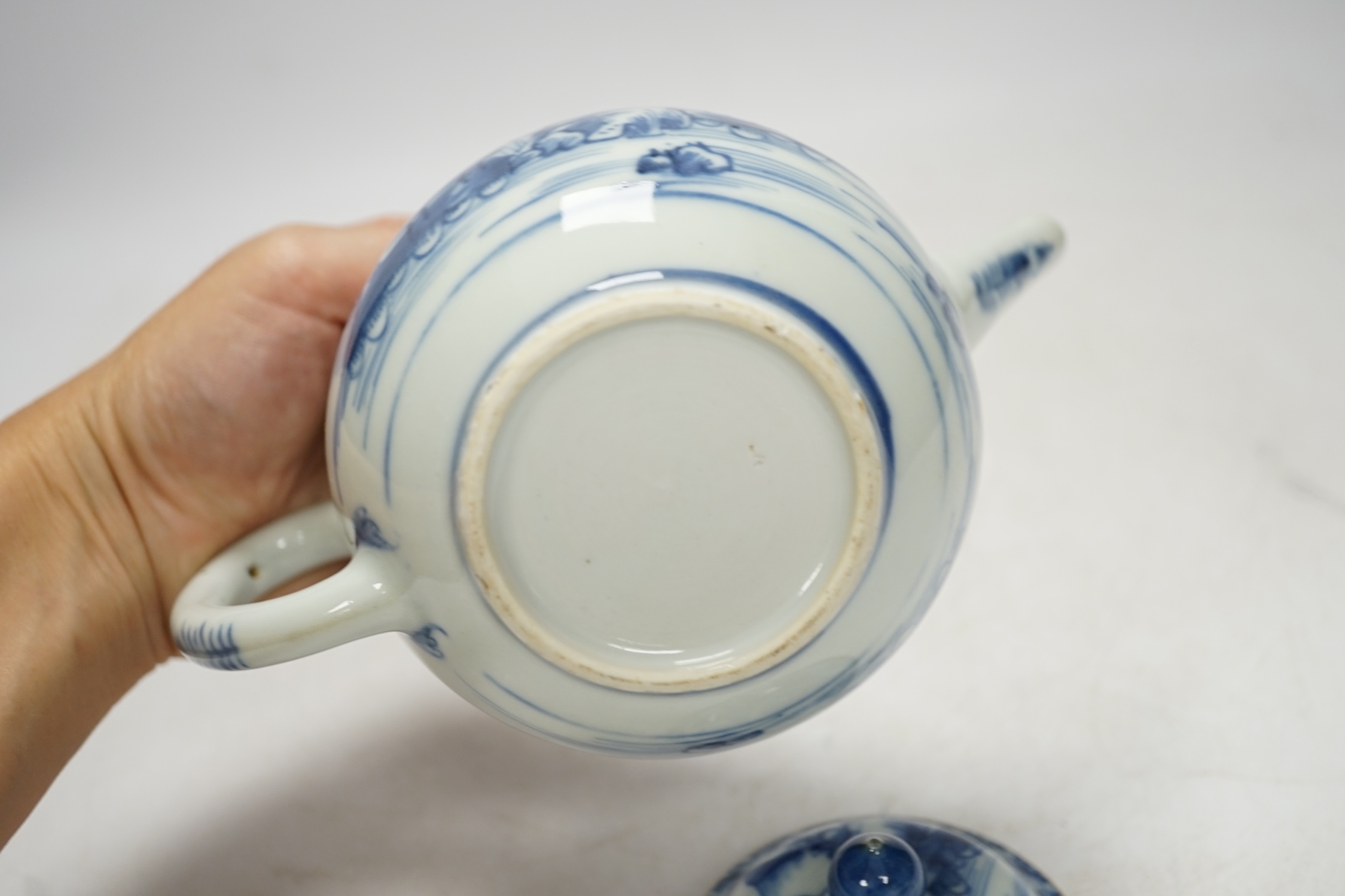 An 18th century Chinese blue and white teapot and cover, 12cm high. Condition - poor